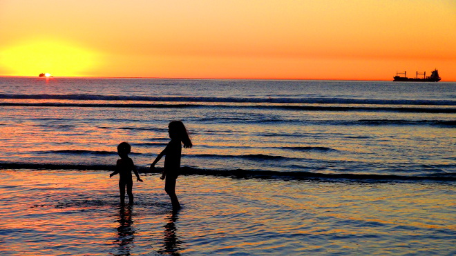 children playing on lagoon beach