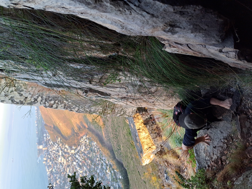 Man scrambling up the Fresnaye Crack on Lions Heads