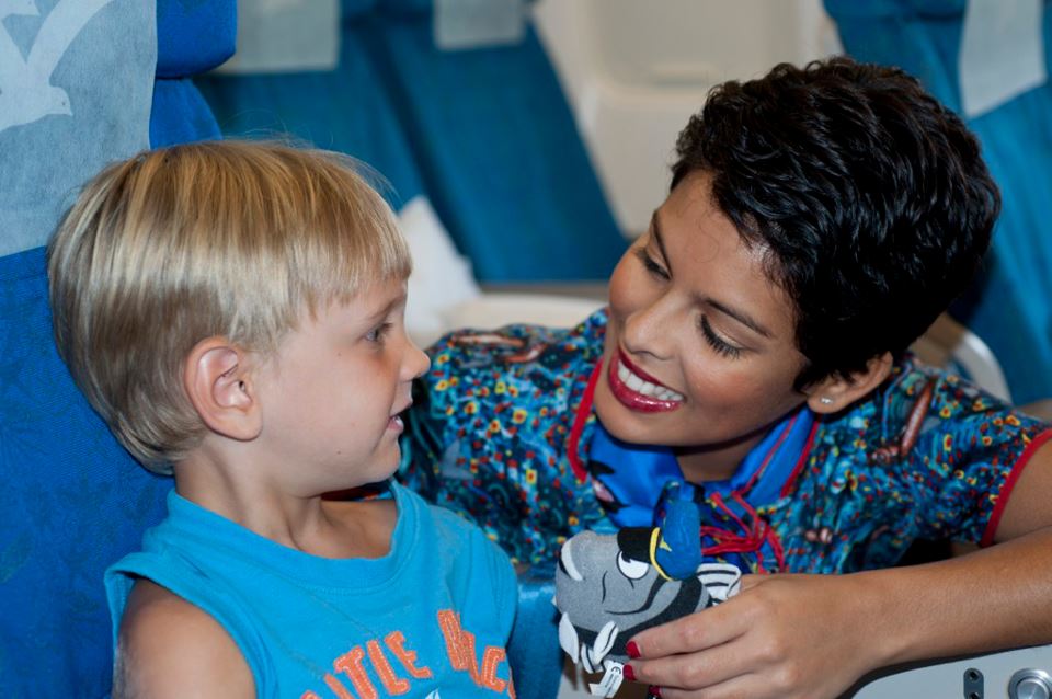 Air Seychelles cabin crew member looking after a child