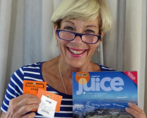 HappypPassenger holding Mango tickets & Juice magazine