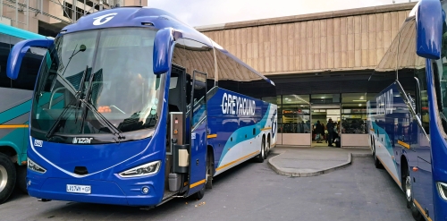Two Greyhound buses parked at the Greyhound boarding gate at Cape Town Bus Station