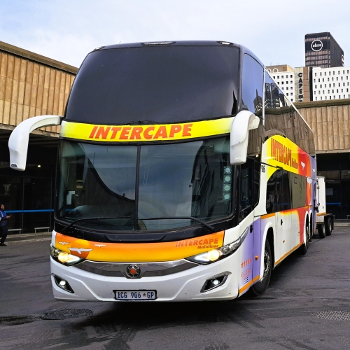 Intercape Mainliner coach parked at Cape Town Station with the Absa building visible in the background