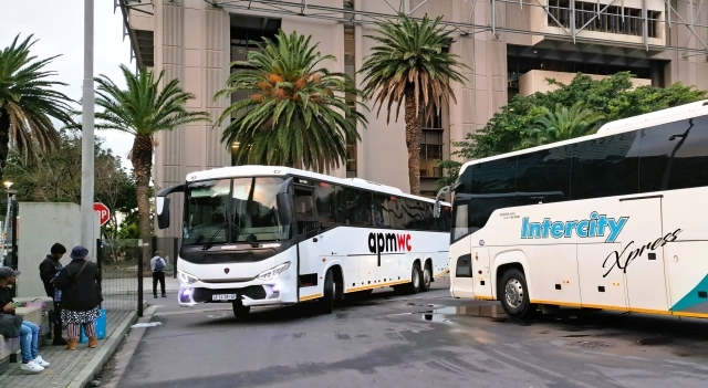 APM WC bus entering Cape Town station while an Intercity Xpress bus leaves