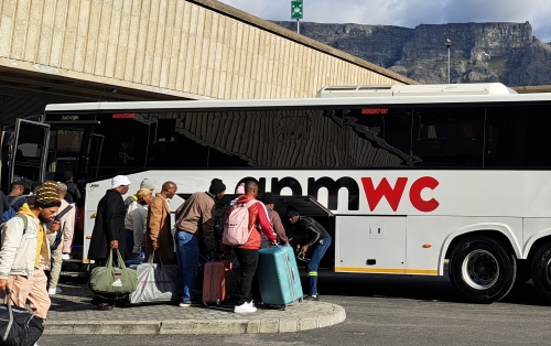APM WC bus being boarded at Cape Town Station with Table Mountain in the background