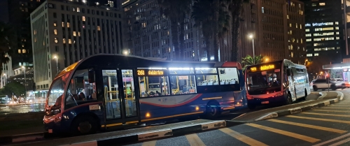 Two MyCiti buses parked in Adderley Street at the circile by Cape Town Station on a Saturday night