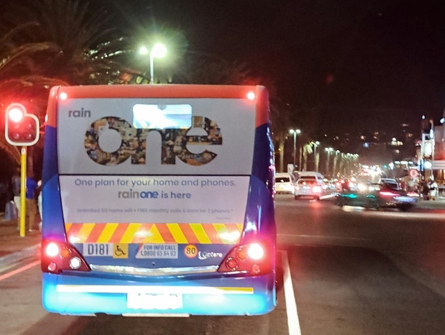 MyCiti bus stops at the traffic lights in Camps Bay at night