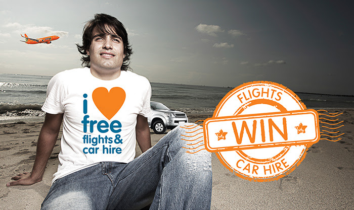 Guy with T-shirt saying "I love free flights & car hire" with Mango plane in background