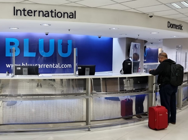 Bluu Car Rental international and domestic kiosks, with somebody collecting their vehicle