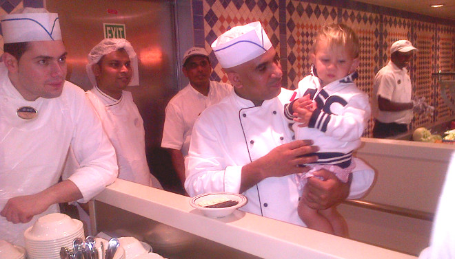 waiter holding a toddler on the cruise ship