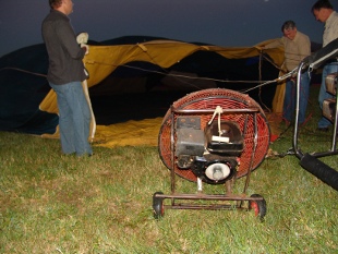 fanning the balloon to fill it with air
