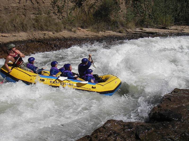 going down a rapid - white water rafting